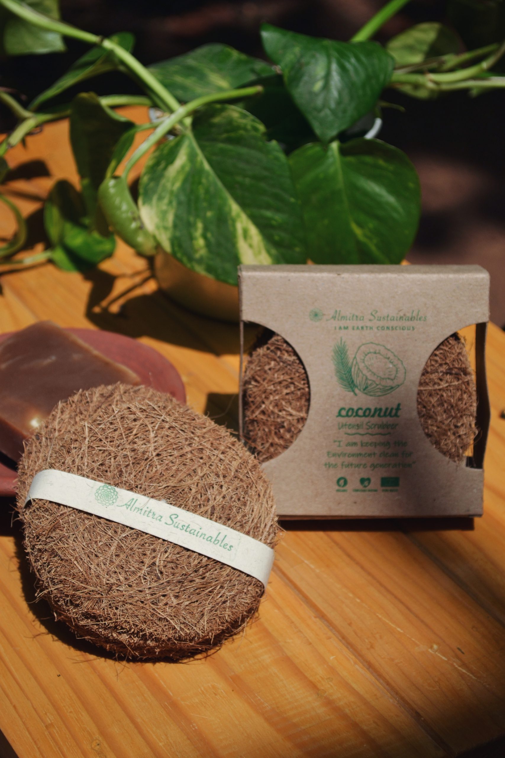 A close-up of a round coconut fiber scrubber made from natural coir, placed inside a stainless steel bowl. The eco-friendly scrubber is made from biodegradable coconut husk, ideal for sustainable kitchen cleaning.